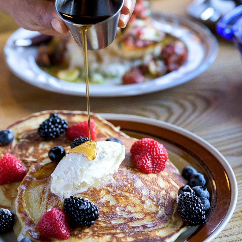 Pancakes with berries and syrup