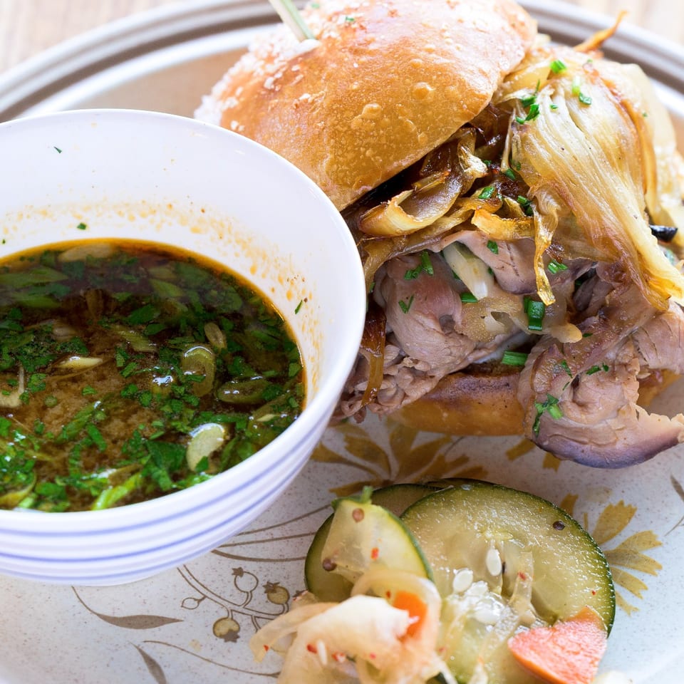 Sandwich with dipping broth and pickles